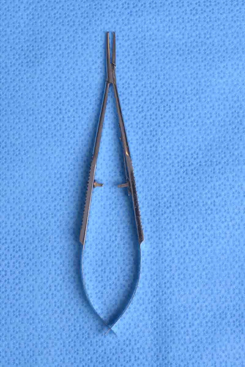Available in various sizes, the locking system on this needle holder ensures a firm grasp of the needle. It is used to pass most needles in oculoplastic procedures, including tagging of the extraocular muscles during enucleation and closing a blepharoplasty incision. The tying platform allows for grasping of the needle during reloading or for grasping of suture while tying. Additionally, the design of the handle allows for improved flexibility and mobility as the surgeon can easily rotate it within his or her hand.